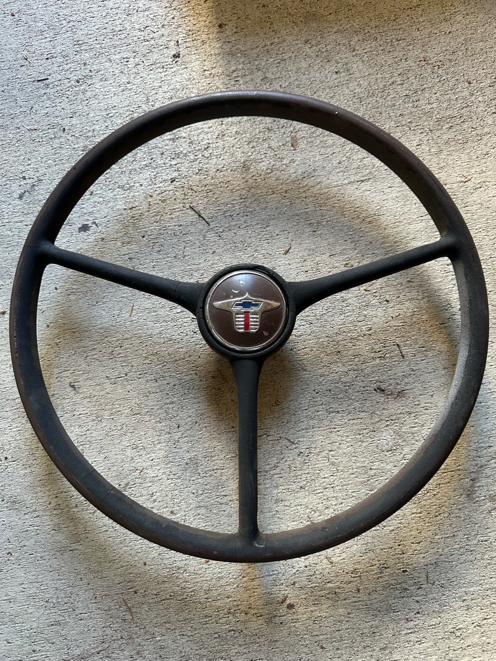 vintage three-spoke brown or dark-colored Chevrolet steering wheel classic logo